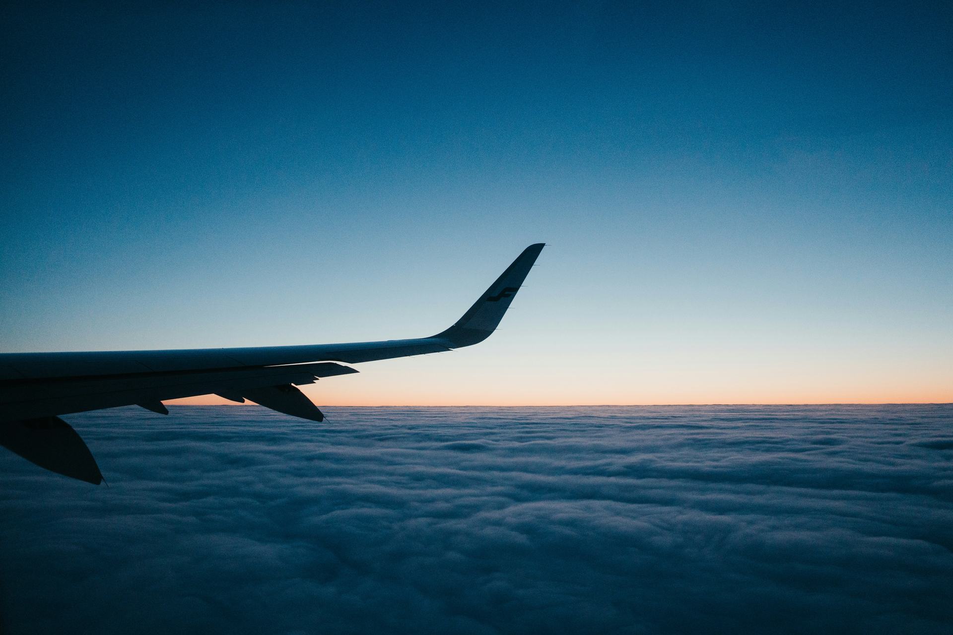 Wing over cloud at dusk